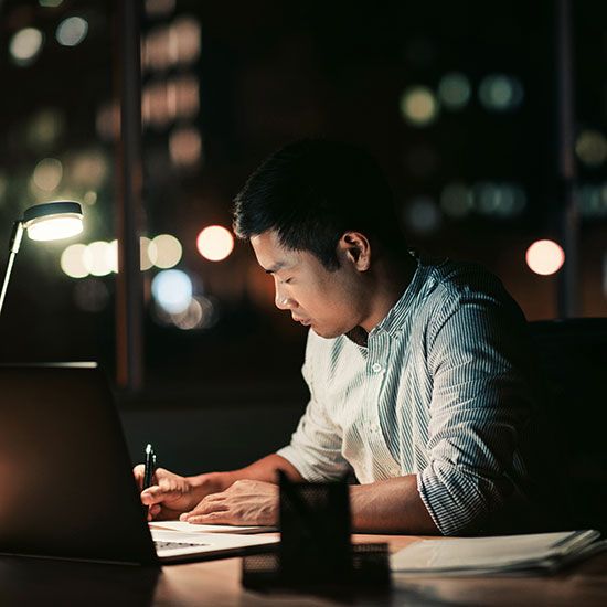 Man in office at night doing paperwork
